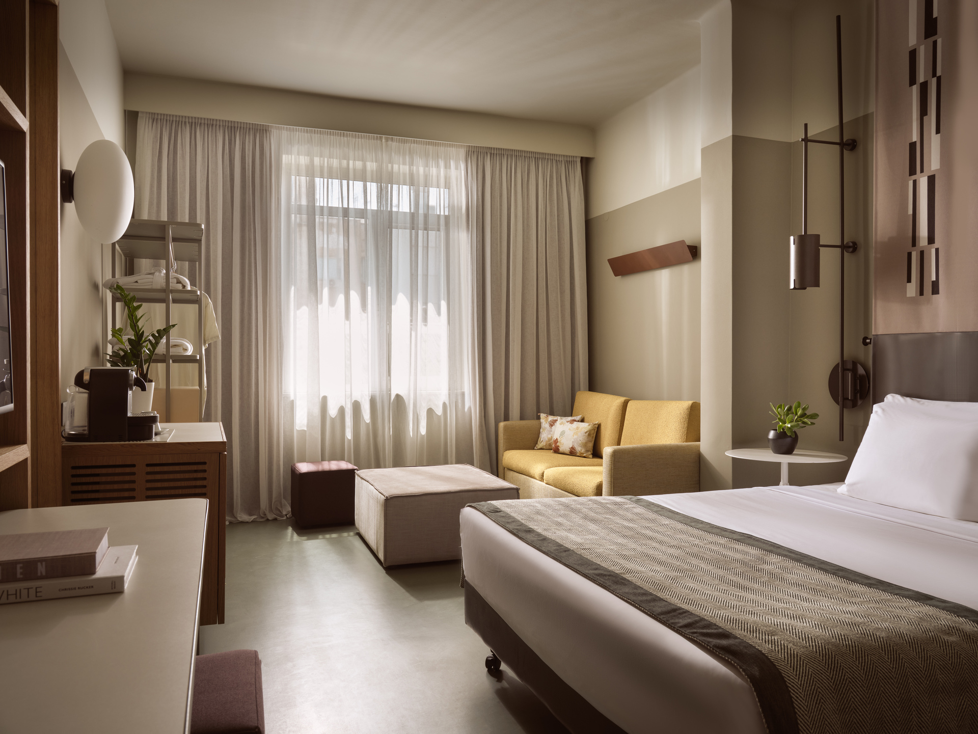 
Junior Suite City View at City Hotel with large window, stylish sitting area, and king-size bed