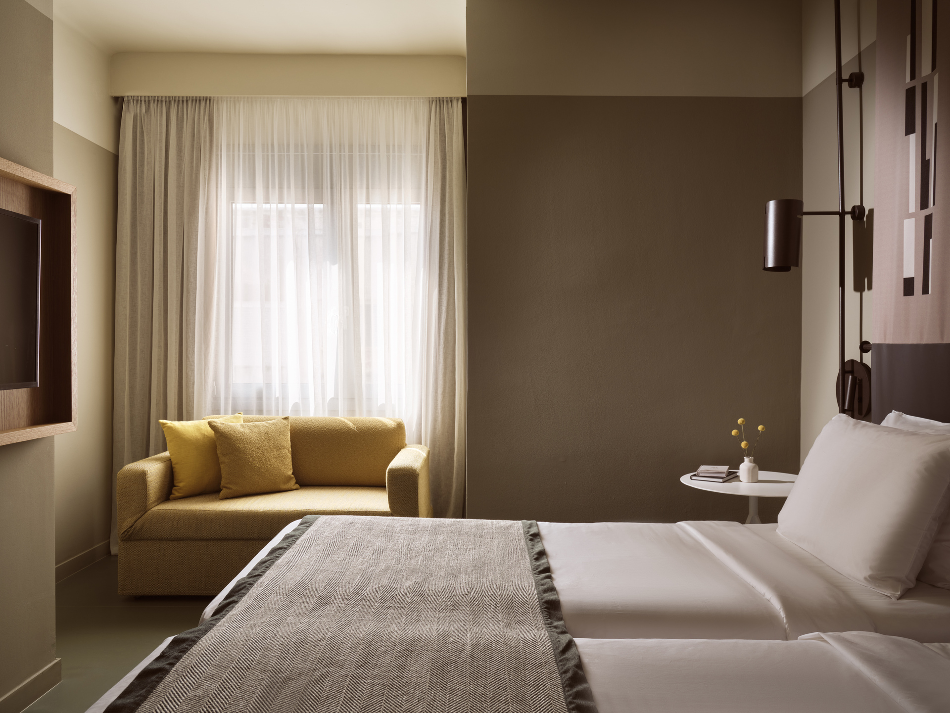 
Superior Room Inner View at City Hotel with twin beds, cozy yellow sofa, and modern lighting