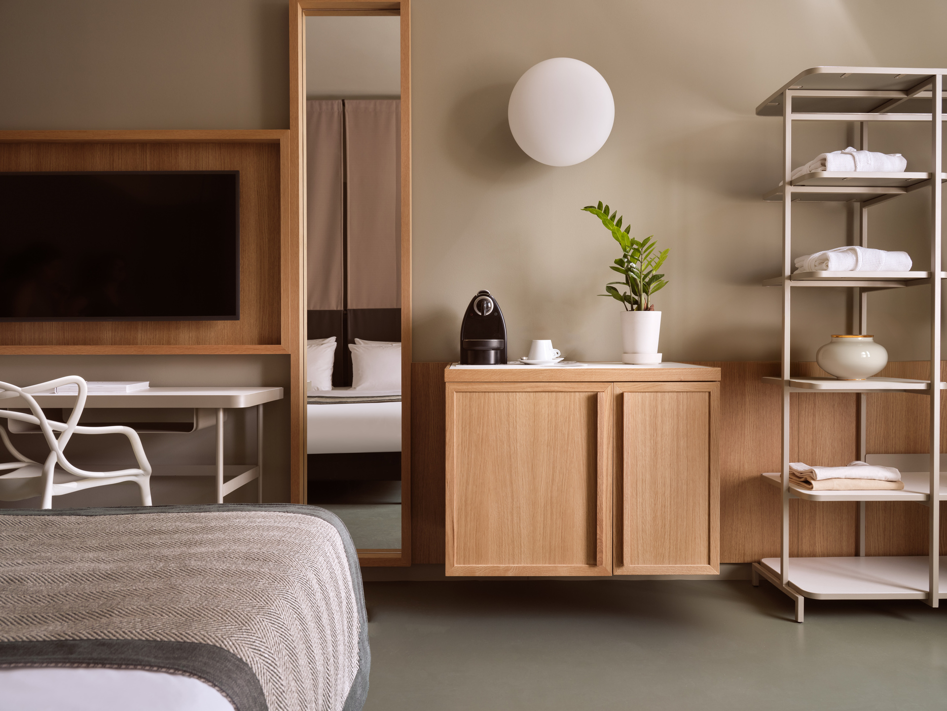 
Junior Suite City View at City Hotel featuring modern decor, flat-screen TV, coffee station, and open shelving