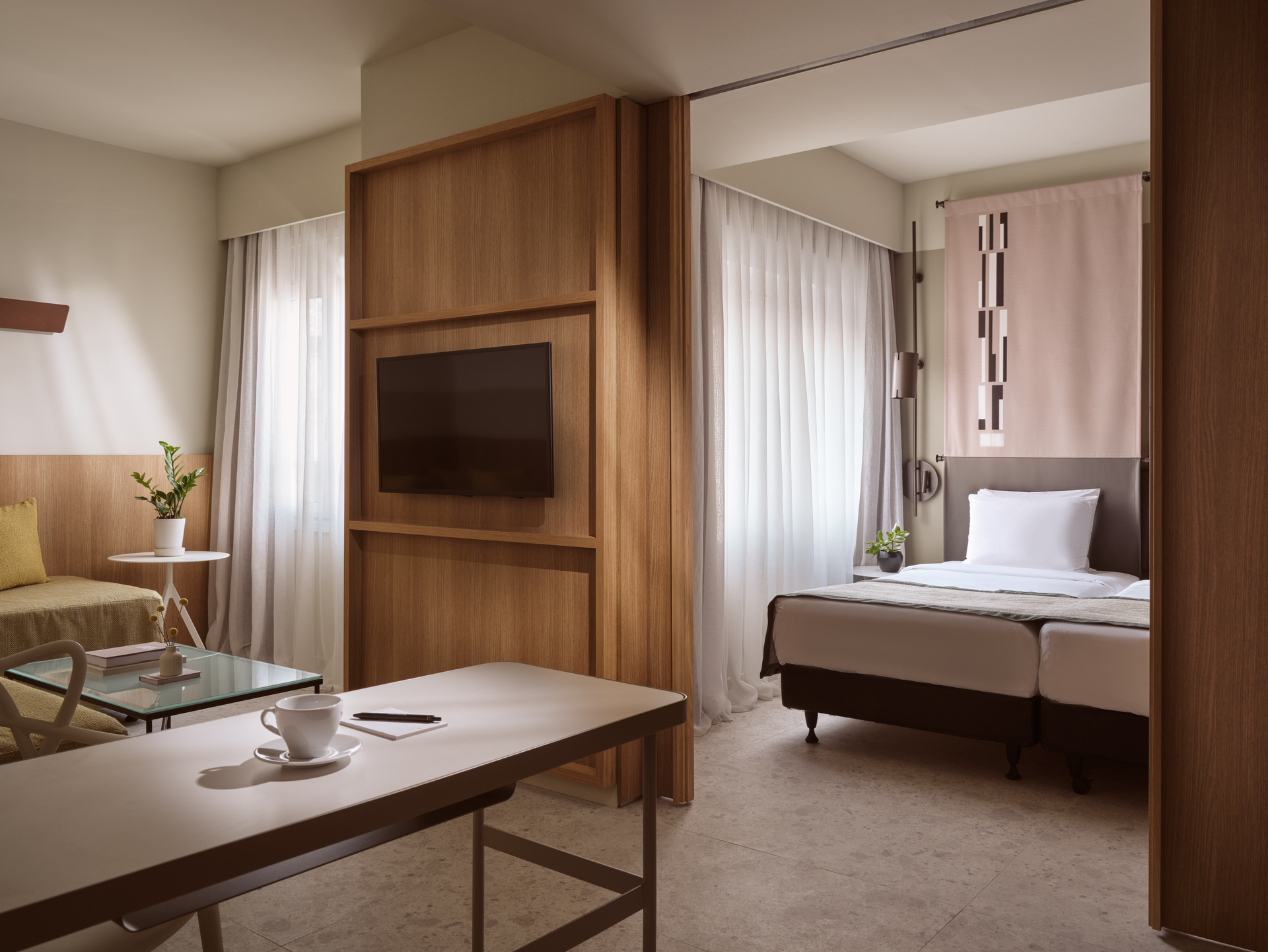 
Junior Suite Inner View at City Hotel with divided sleeping area, lounge, and modern décor